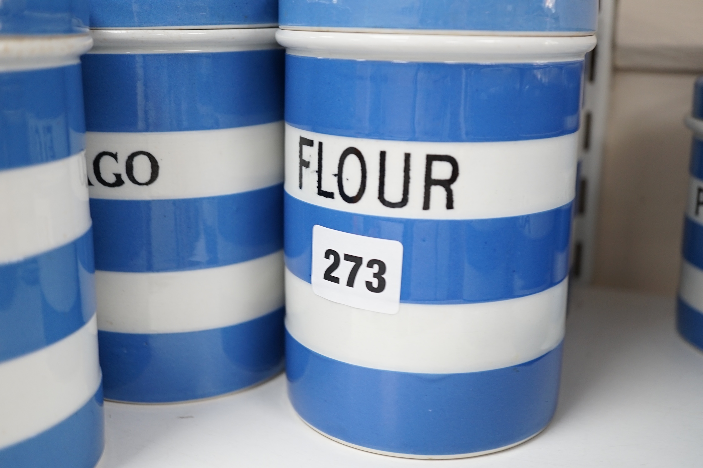 T.G.Green Cornish Kitchenware, nine 14cm lidded storage jars to include Custard Powder, Sago, Tapioca, Brown Sugar, Bread Crumbs and Prunes, Black Shield marks. Condition - fair to good